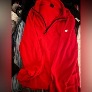 Two apple employee shirts- one red fleece half zip and one black hoodie